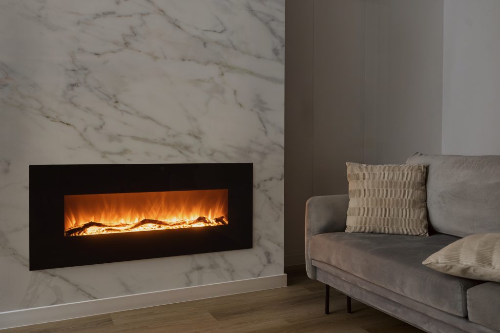Modern electric fireplace mounted on marble wall in cozy living room with LED flame effect