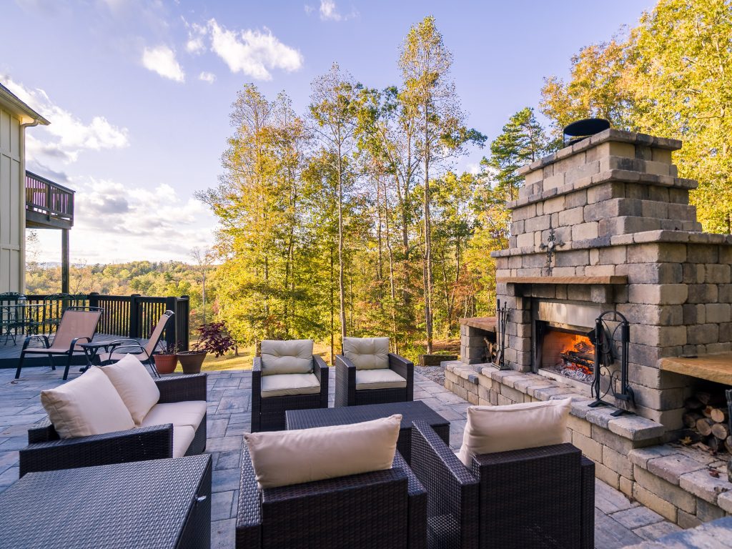 Stunning stone outdoor fireplace transforming patio into cozy year-round gathering space