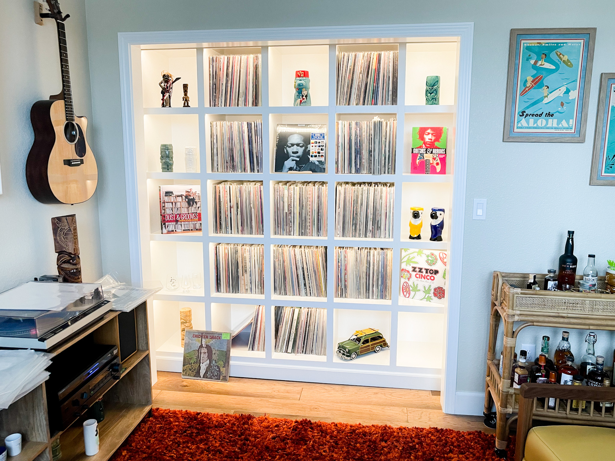 Custom built-in shelving unit with LED backlighting displaying a vinyl record collection